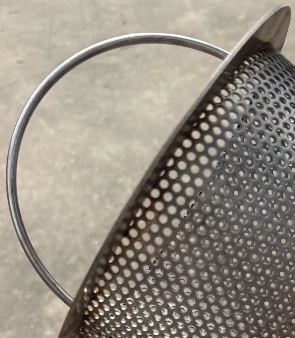 Wire handle of a stainless steel skimmer basket.
